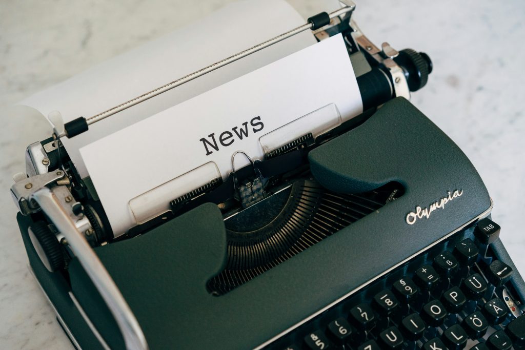 typewriter with word news printed on paper